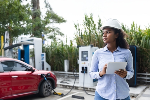 photo of woman charging her car