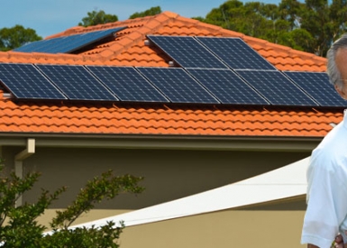 Couple in front of home with solar panels